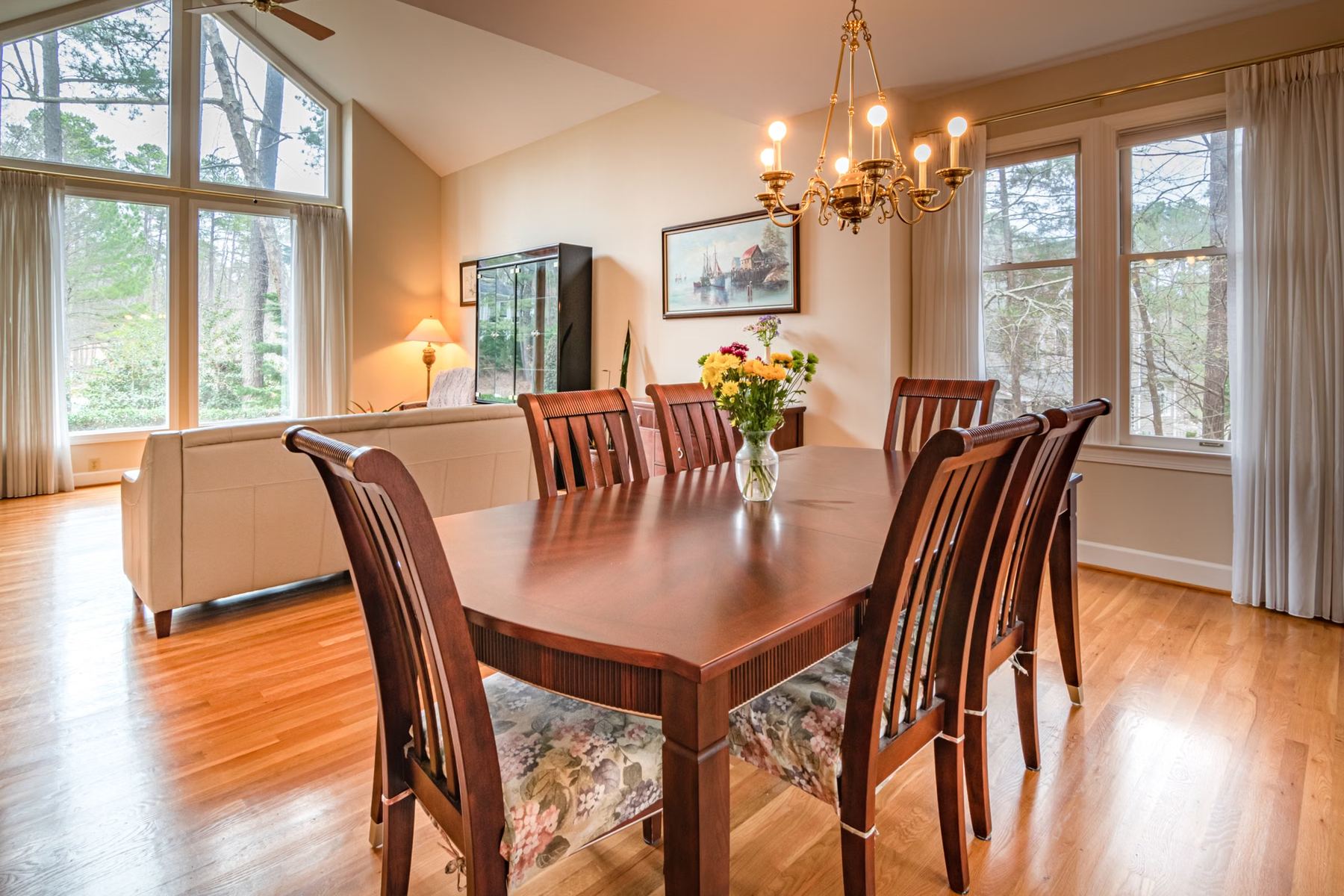 Warm dining room with a wooden table and chairs by a window